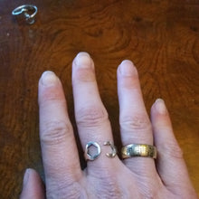 Load image into Gallery viewer, Sterling silver wrench ring wide, next to a gold tire ring